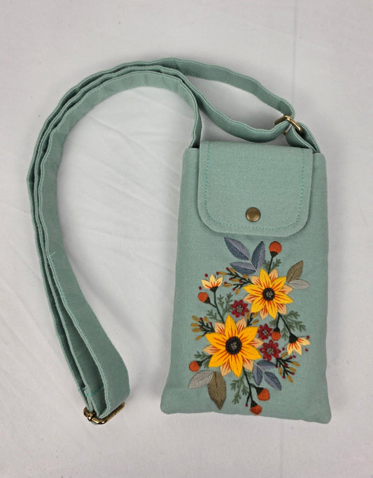 Mint green handbag with floral design on a white background
